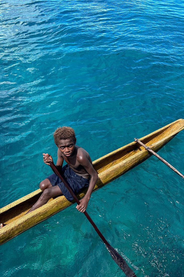 Residents of Tungelo Island in their traditional dugout canoes, New Ireland province, Papua New Guinea