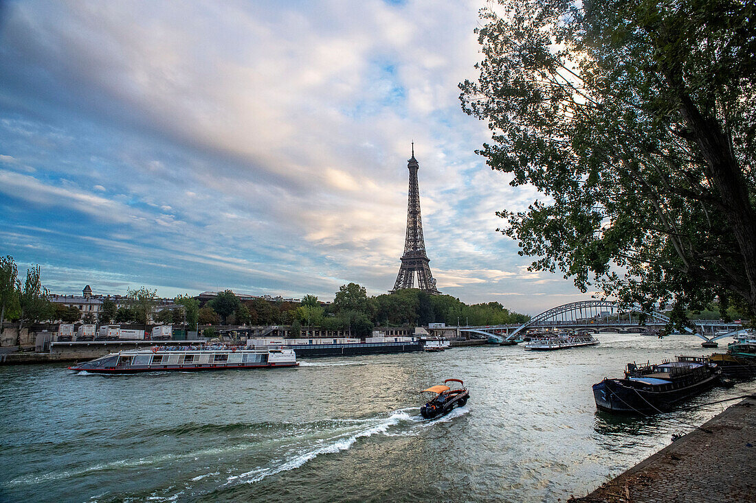 Passenger touristic cruise ship in the Seine river is moored to the pier near Eiffel Tower