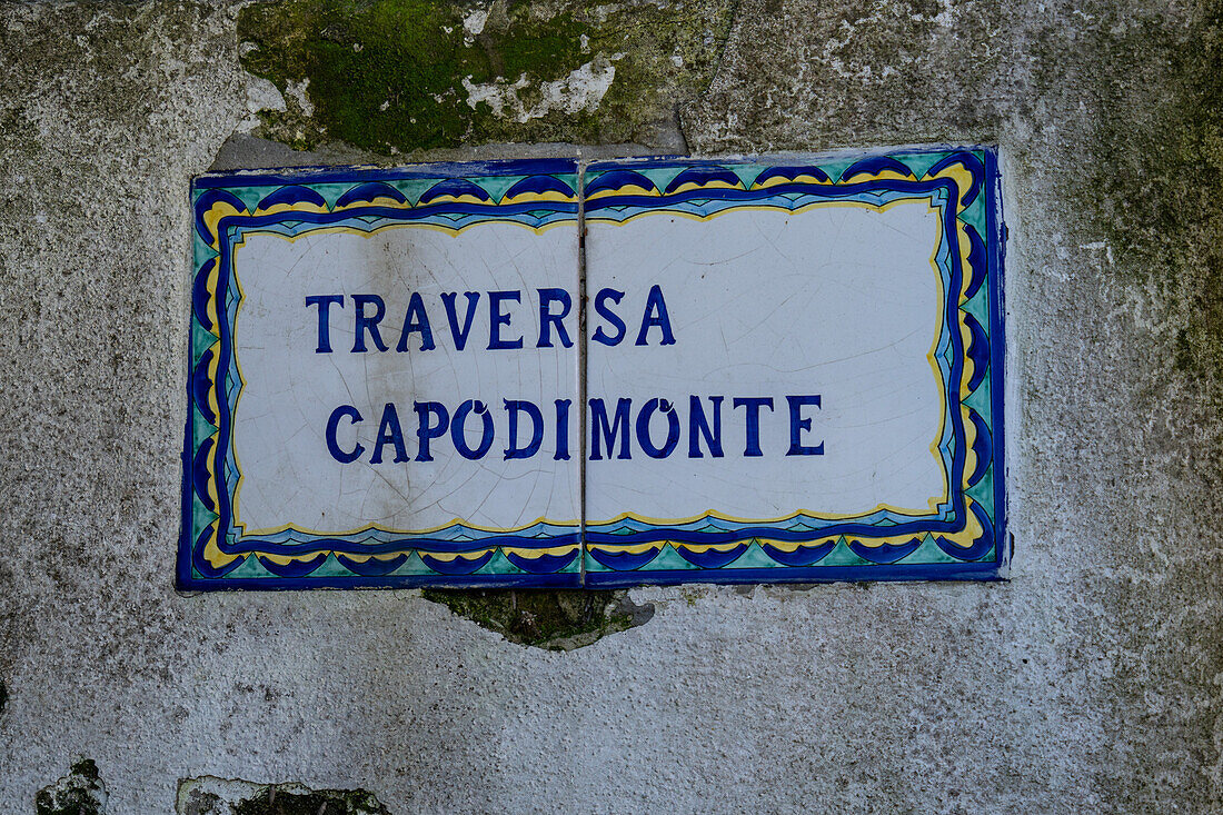 Ceramic street sign on the wall of the Casa Rossa in Anacapri on the island of Capri, Italy. Beside it is a Roman column.