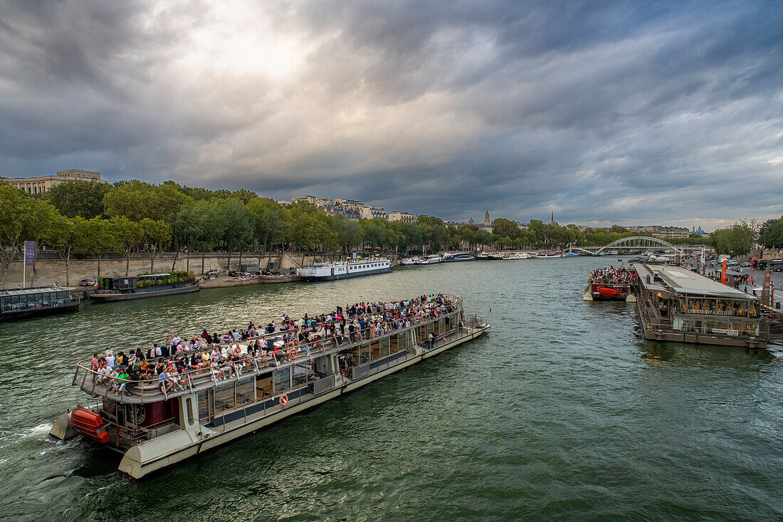 Passenger touristic cruise ship in the Seine river is moored to the pier near Eiffel Tower