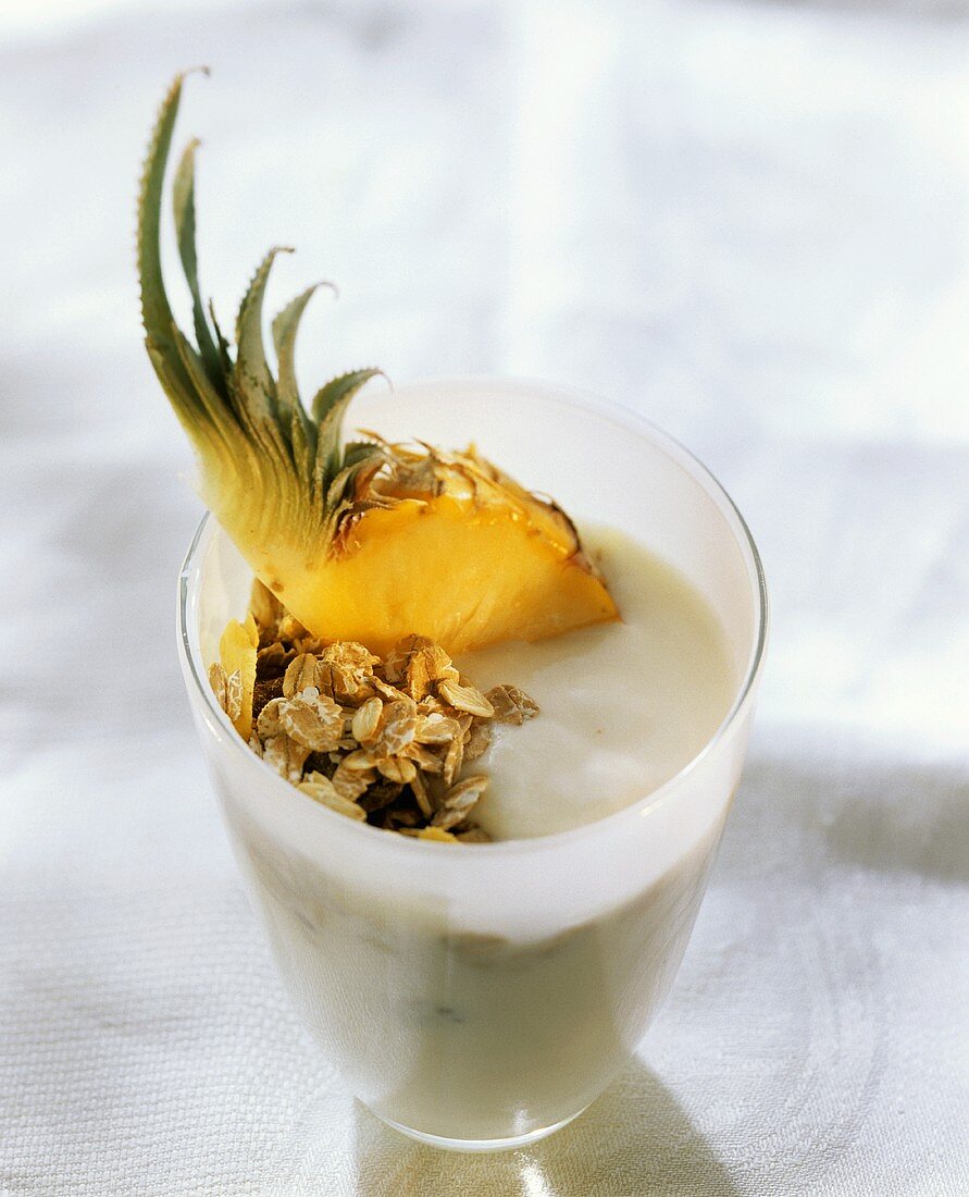 Yoghurt with pineapple and oat flakes in pot