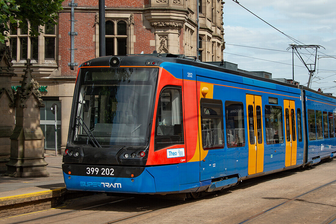 Sheffield tram (Supertram) approaching a stop in Church Street, Cathedral Quarter, Sheffield, Yorkshire, England