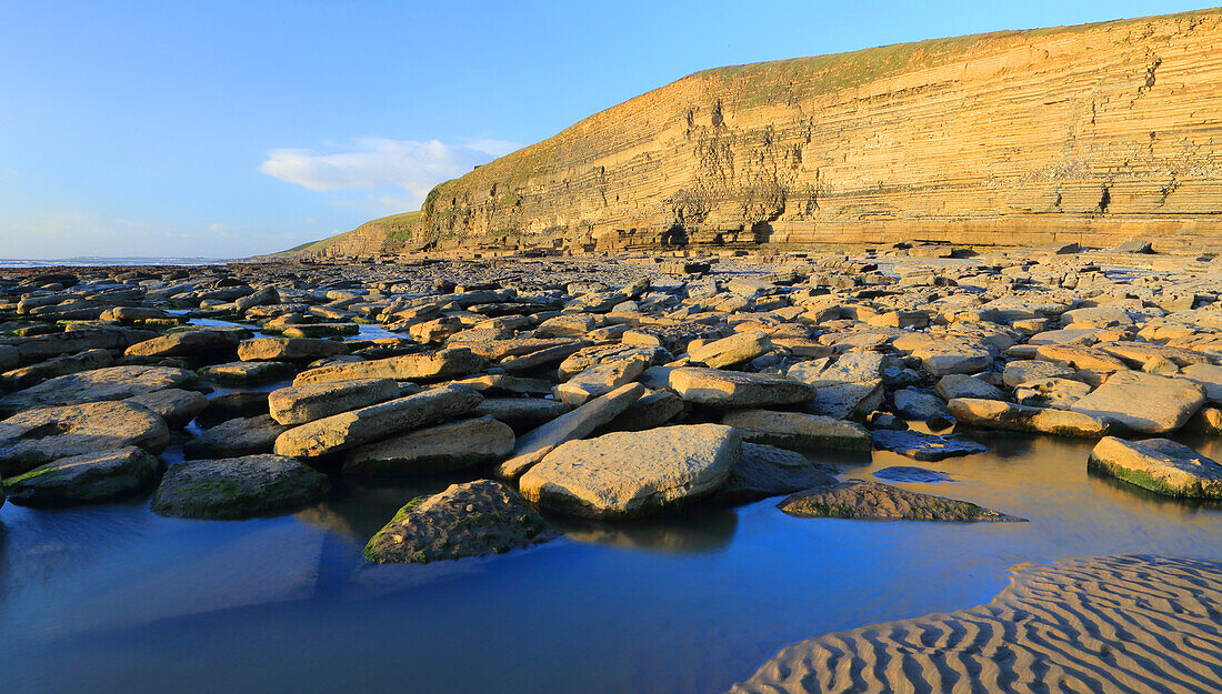 Limestone cliffs and beach, Dunraven Bay, Southerndown, Vale of Glamorgan, South Wales, United Kingdom