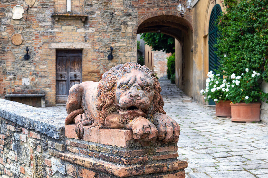 A stone lion guarding the traditional village of Lucignano d'Asso, comune of Montalcino, Tuscany, Italy