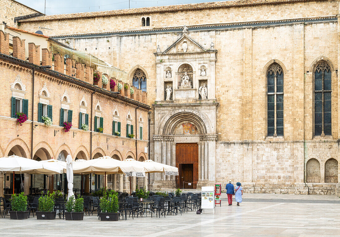 Ein Paar geht zur Kirche San Francesco (Basilica di San Francesco) auf der Piazza del Popolo, Ascoli Piceno, Marken, Italien