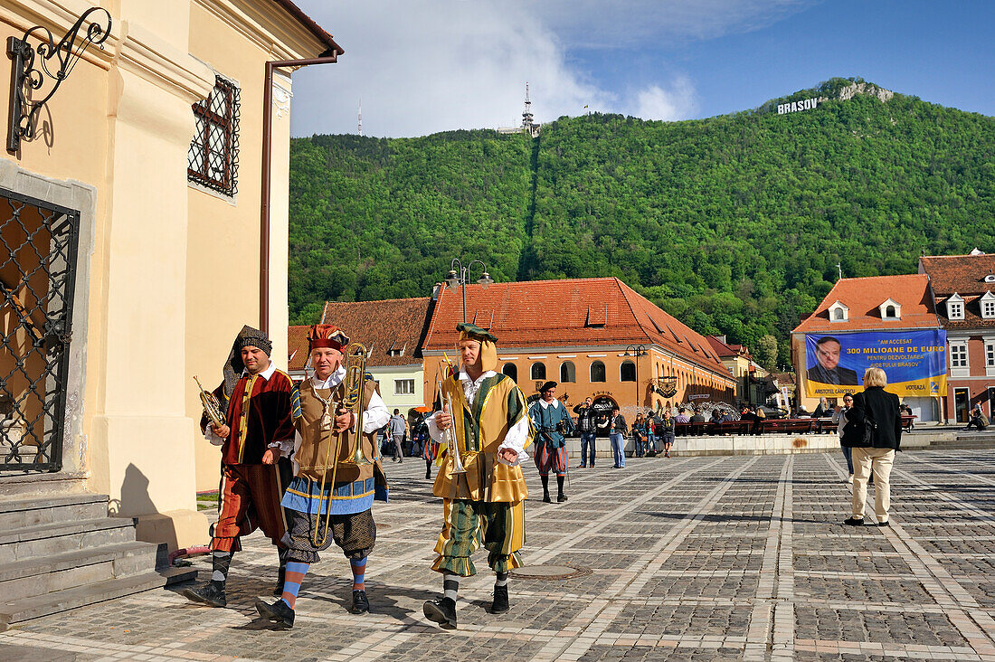 Musicians in medieval costume play a tune each hour from top of the Council House, Council Square (piata Sfatului), Brasov, Transylvania, Romania