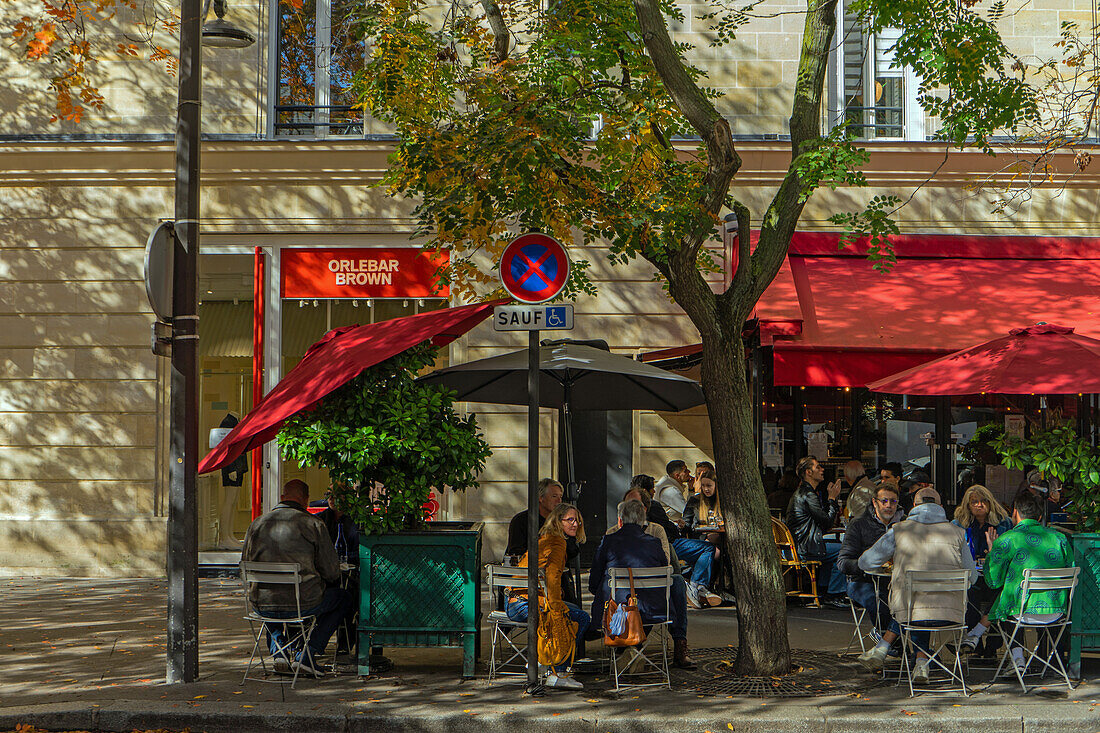 Terrace of restaurant Bar du Marche des Blancs Manteaux on Rue des Vieilles du Temple in autumn sunshine, Paris, France