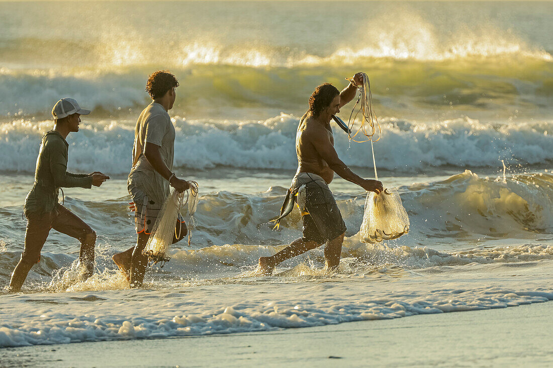 Men with throw nets and freshly caught fish, Nosara Boca (river mouth), local fishing spot, Boca Nosara, Nosara Beach, Guanacaste, Costa Rica