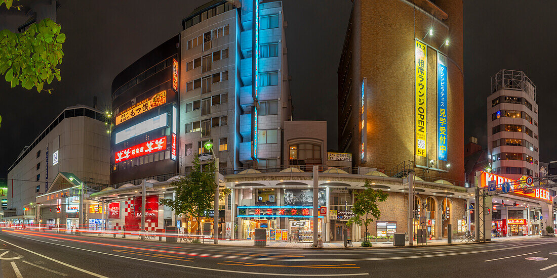 Blick auf eine Straßenszene und Geschäfte in Hiroshima bei Nacht, Hiroshima, Honshu, Japan