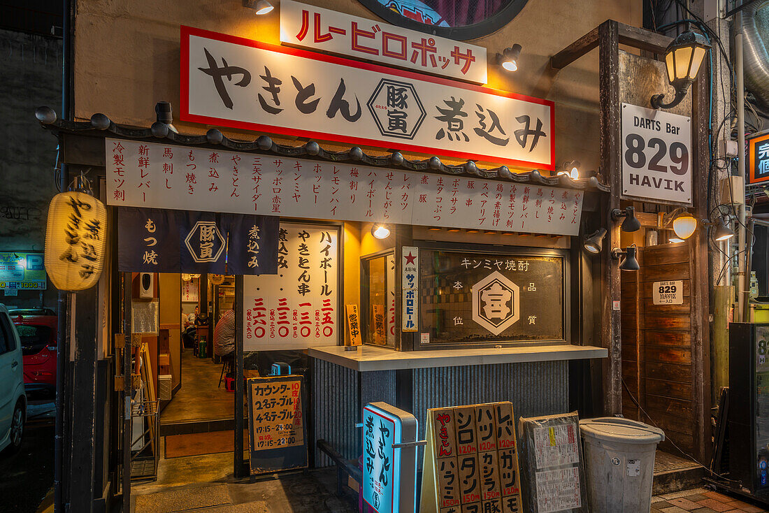 View of colourful Japanese restaurant entrance at night, Hiroshima, Honshu, Japan