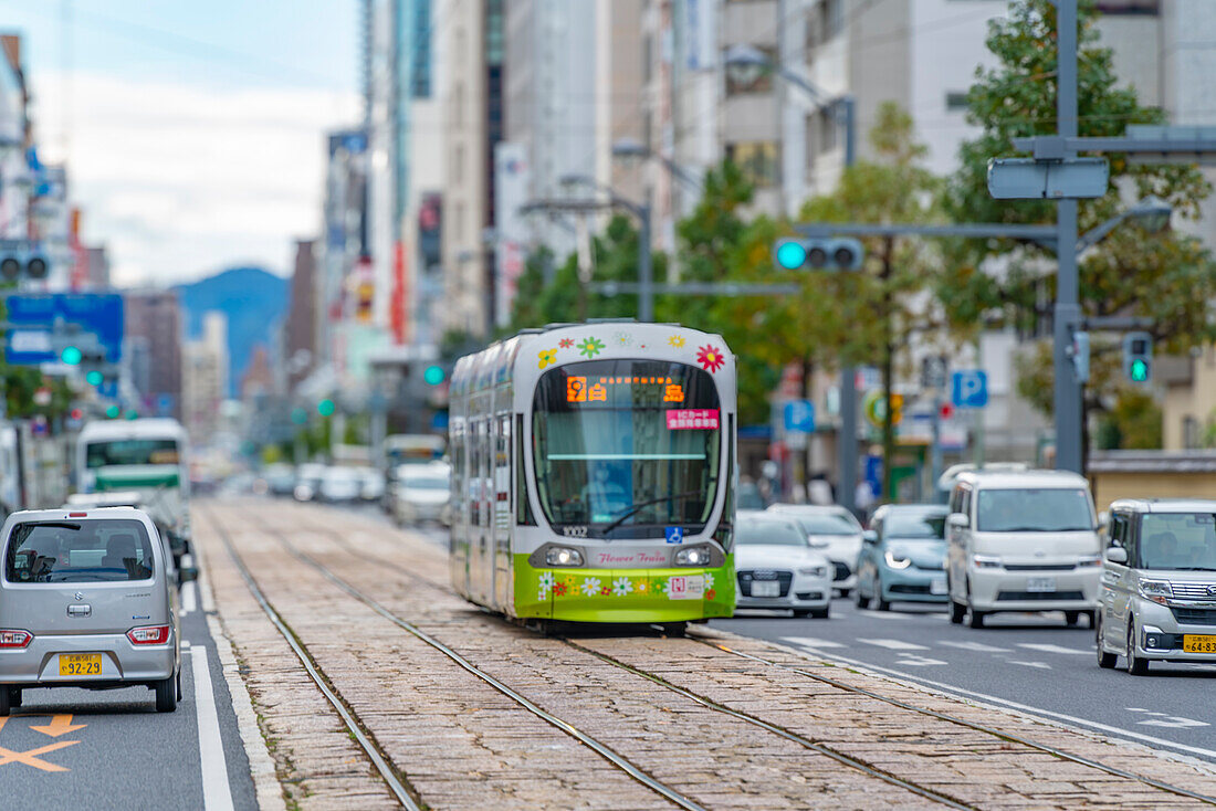 View of city tram on major street during daytime, Hondori, Naka Ward, Hiroshima, Honshu, Japan