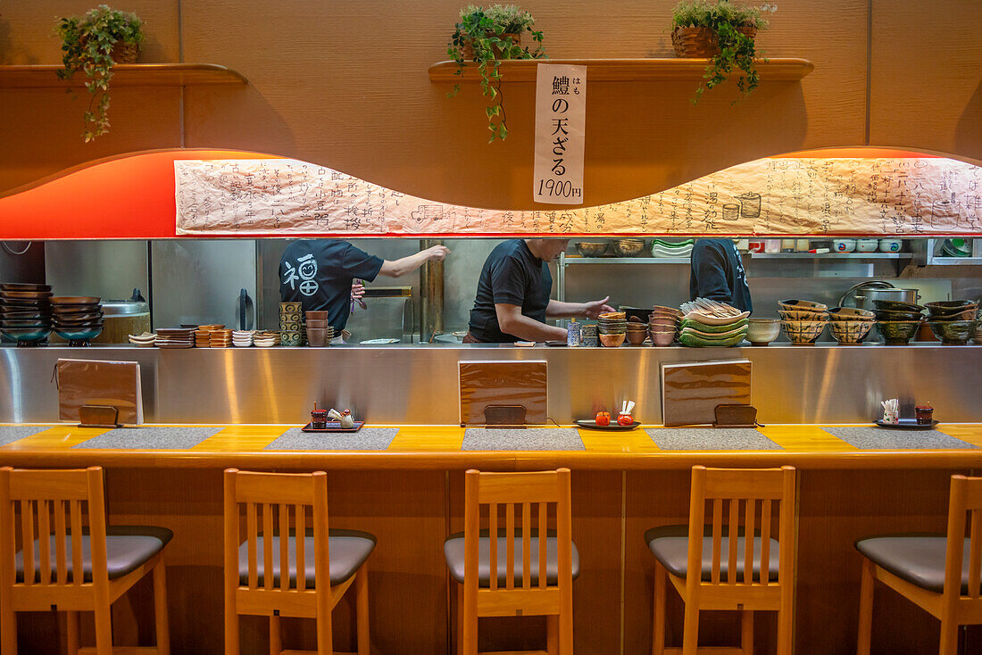 View of chefs busy at work through restaurant window in Omicho Market, Kanazawa City, Ishikawa Prefecture, Honshu, Japan