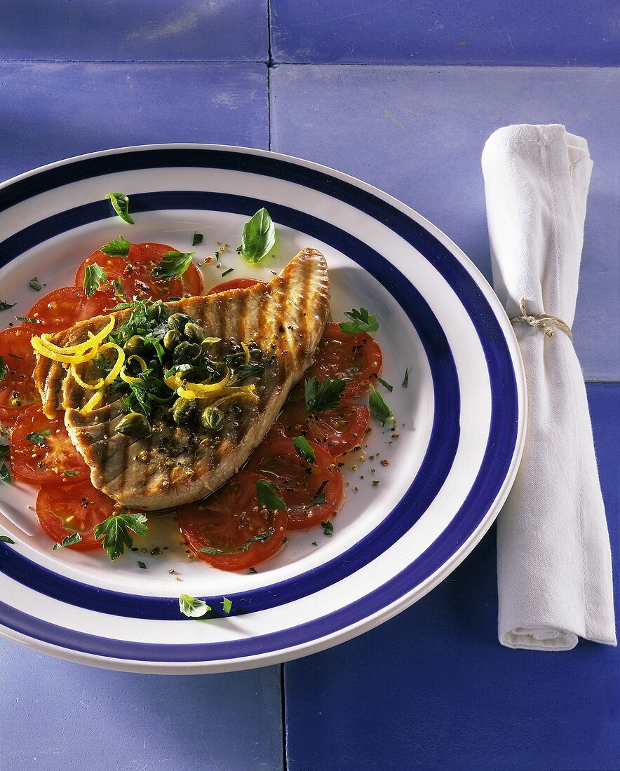 Grilled tuna steak on tomatoes