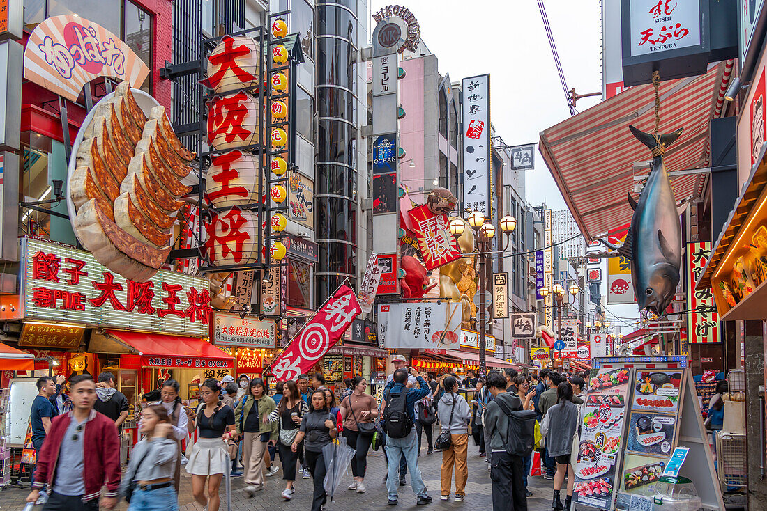 View of colourful signs of restaurants in Dotonbori, vibrant entertainment district near the river, Osaka, Honshu, Japan