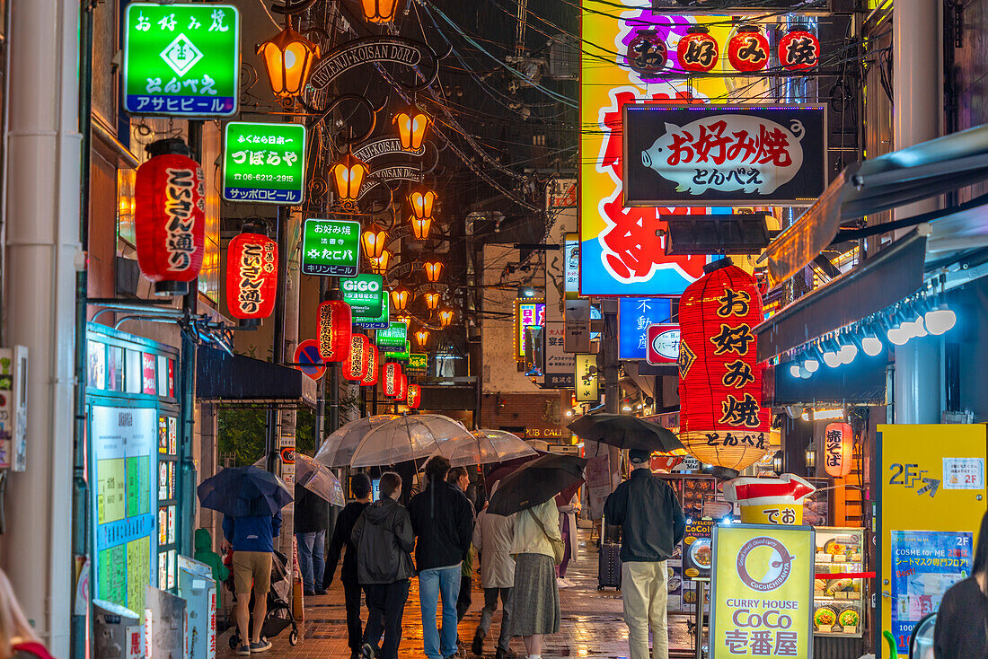 View of colourful signs in backstreet in Dotonbori, vibrant entertainment district near the river, Osaka, Honshu, Japan