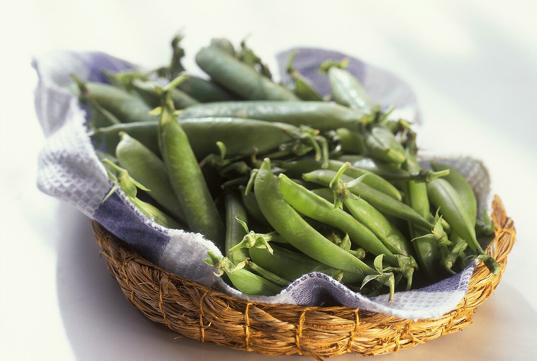 Various pea pods in a bast dish