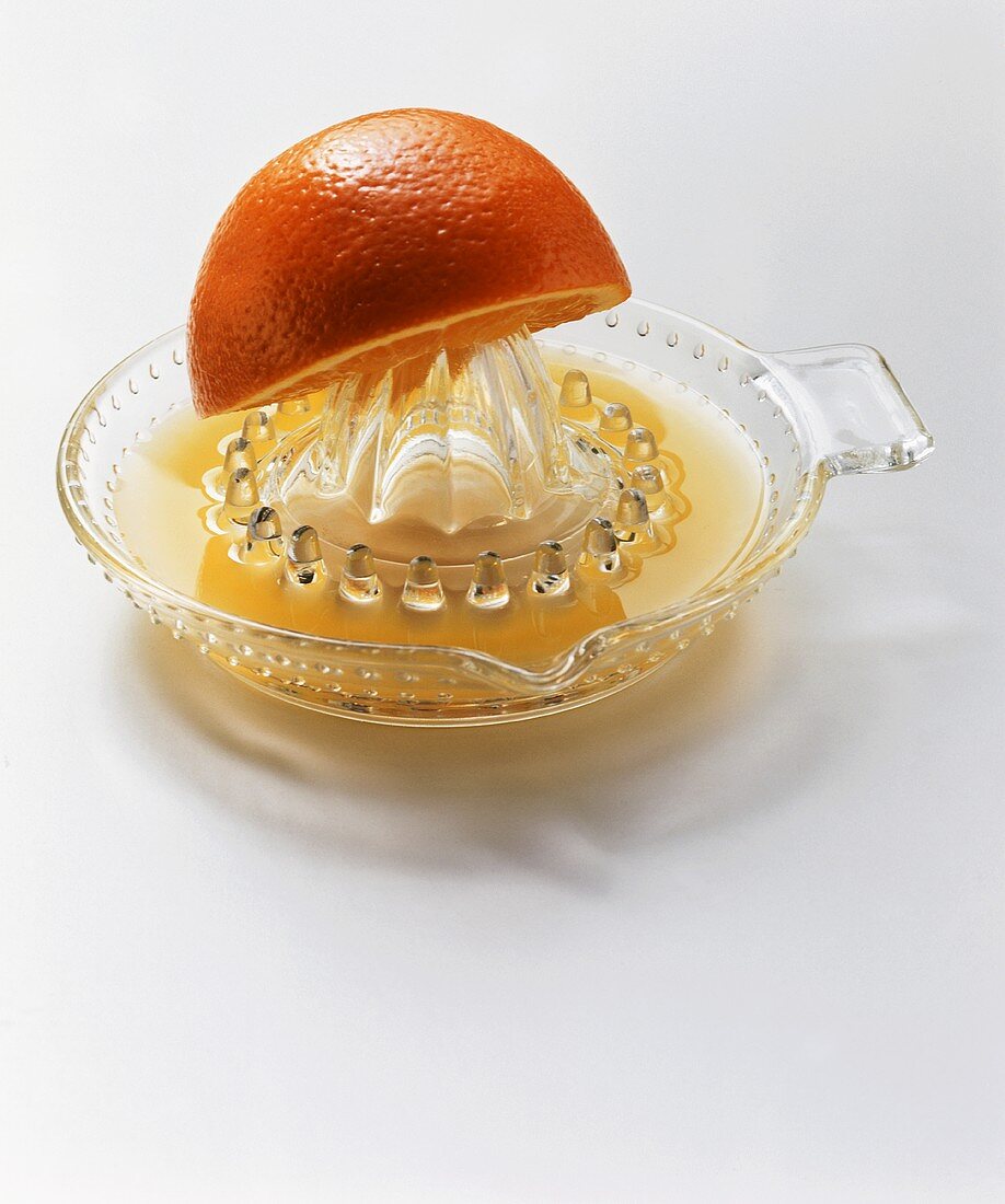 An Orange Half on a Glass Juicer