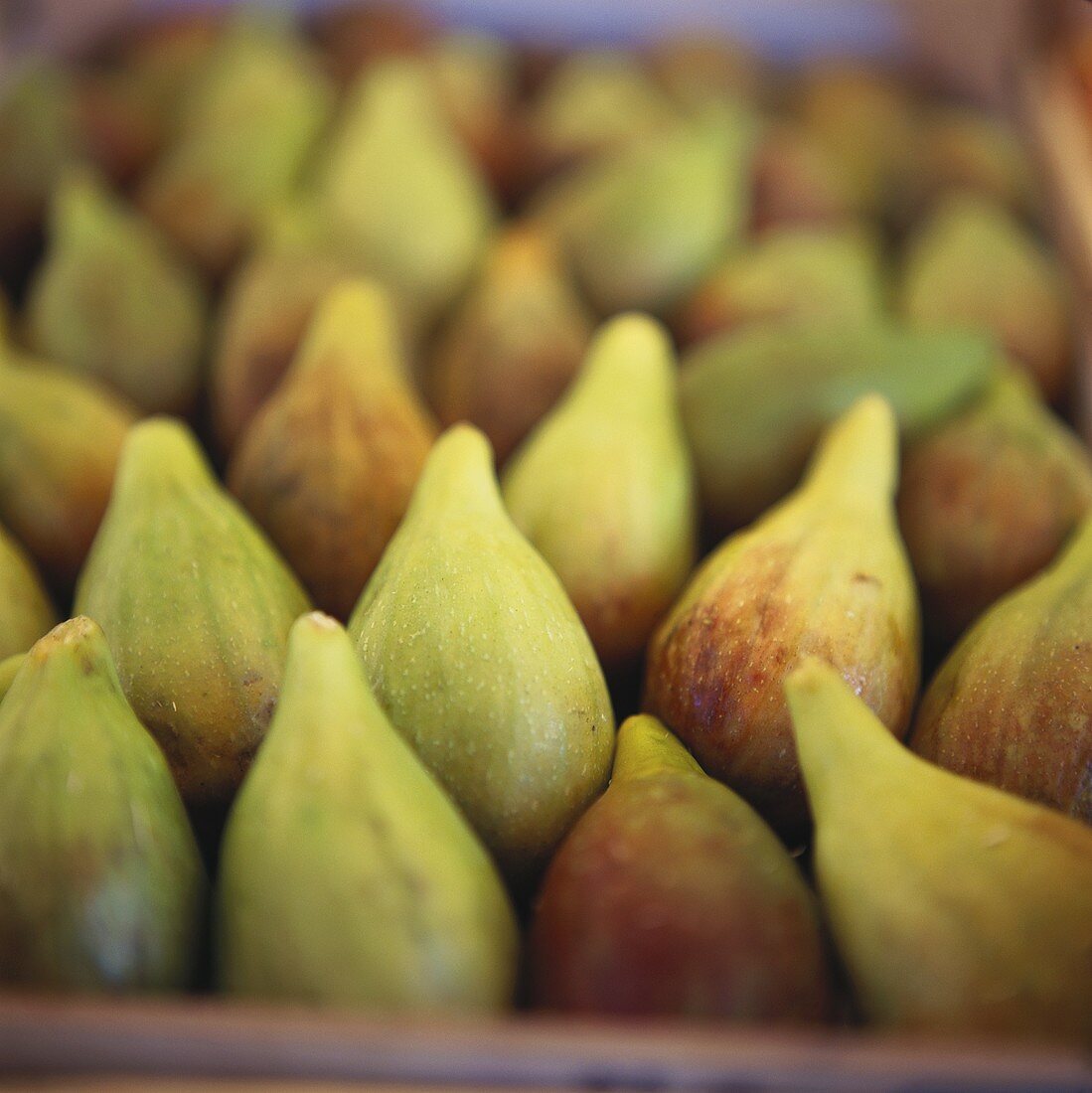 Fresh figs in crate at market (almost filling the picture)