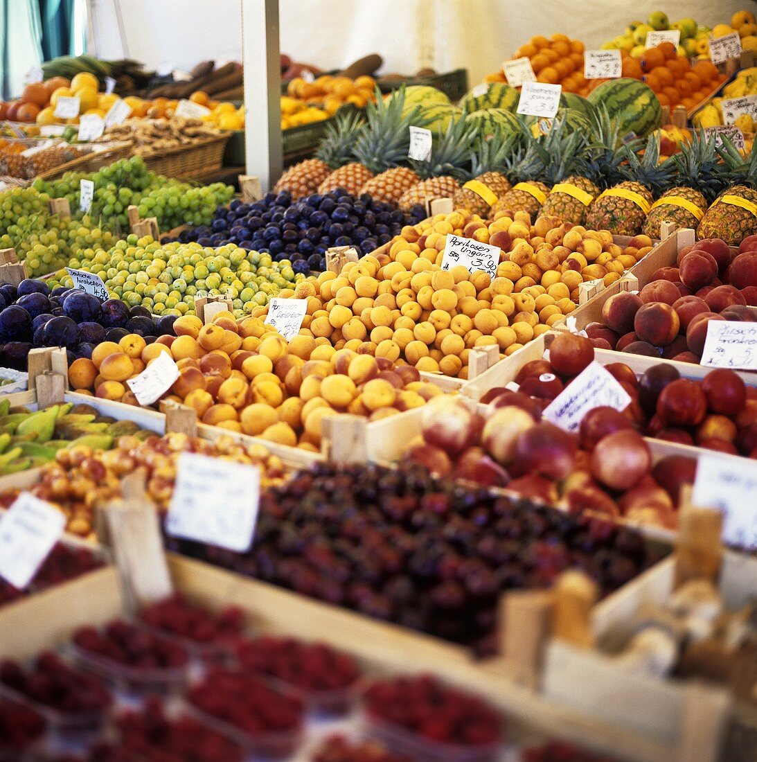 Viele verschiedene Früchte in Steigen auf einem Marktstand