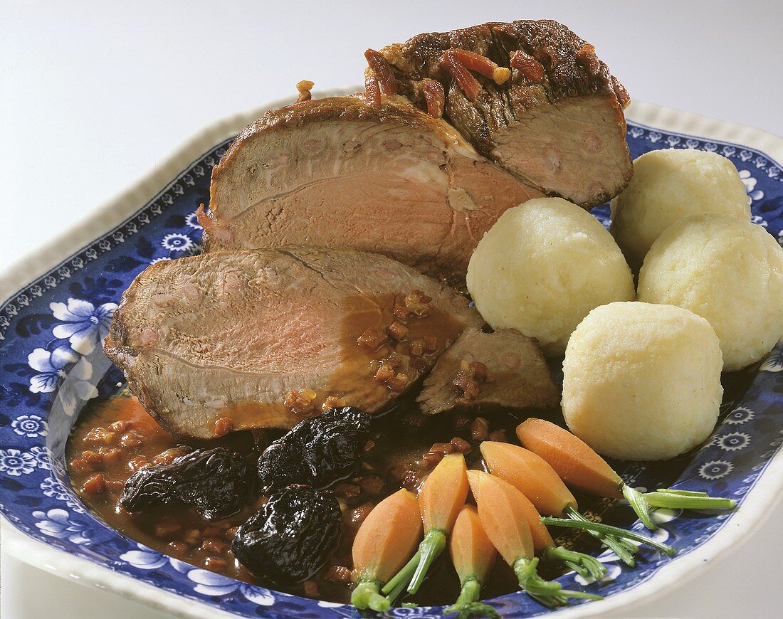 Roast beef with cinnamon & prunes on plate with dumplings