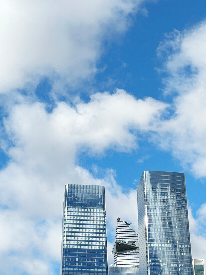 One and Two Manhattan West with 30 Hudson Yards in background against blue sky and clouds, New York City, New York, USA