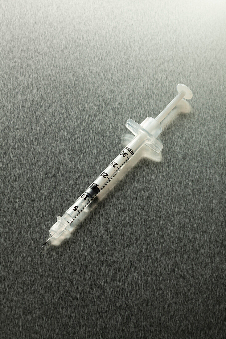 Botox syringe on dark gray background