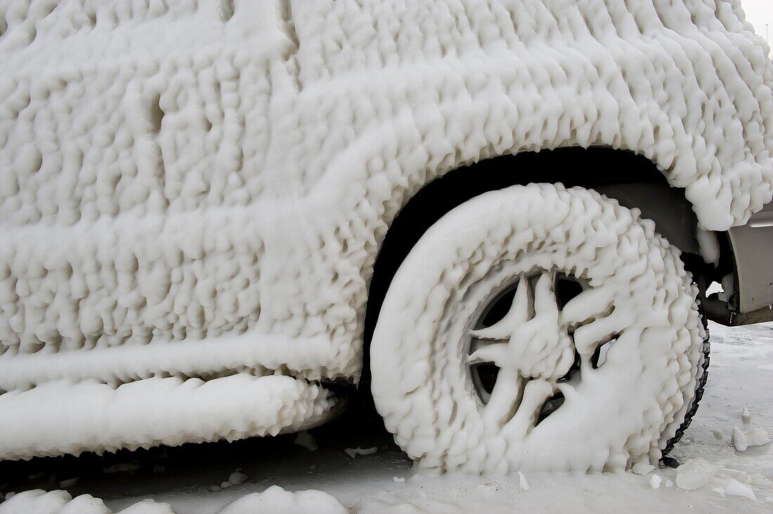 Switzerland, Canton of Vaud, Versoix, the edges of Lake Geneva covered with ice in very cold weather, a car caught by the ice in one night