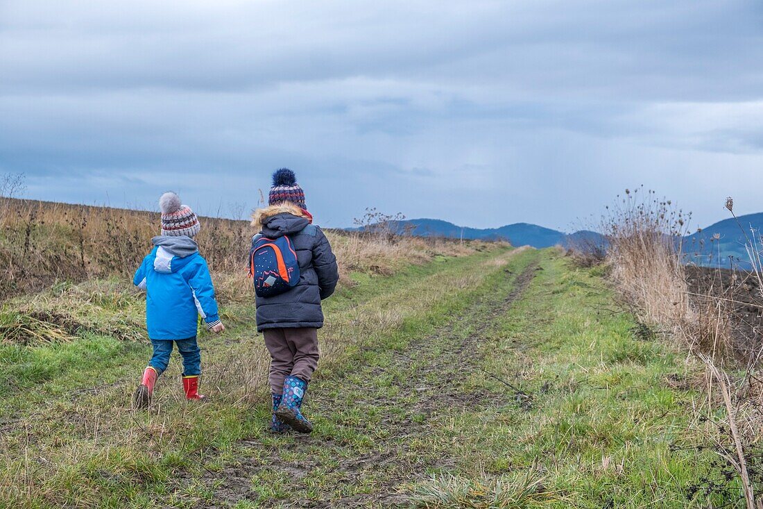 France, Puy de Dome, Billom, two child on a dirt track