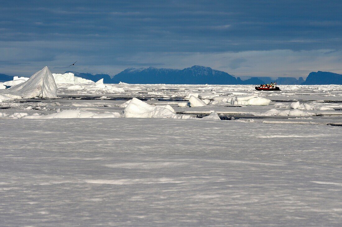 Greenland, North West coast, Smith sound north of Baffin Bay, broken pieces of Arctic sea ice and an exploration zodiac of the MS Fram cruse ship from Hurtigruten