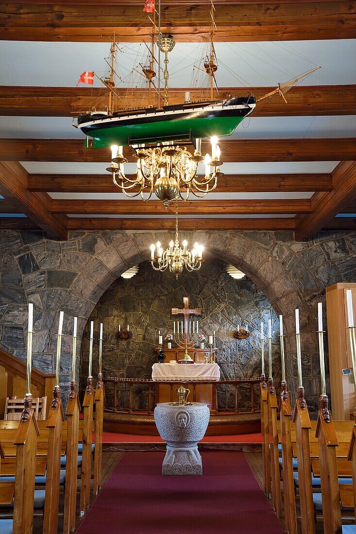 Greenland, west coast, Uummannaq, votive boat in the nave of the granite church, one of the few that is built of stone