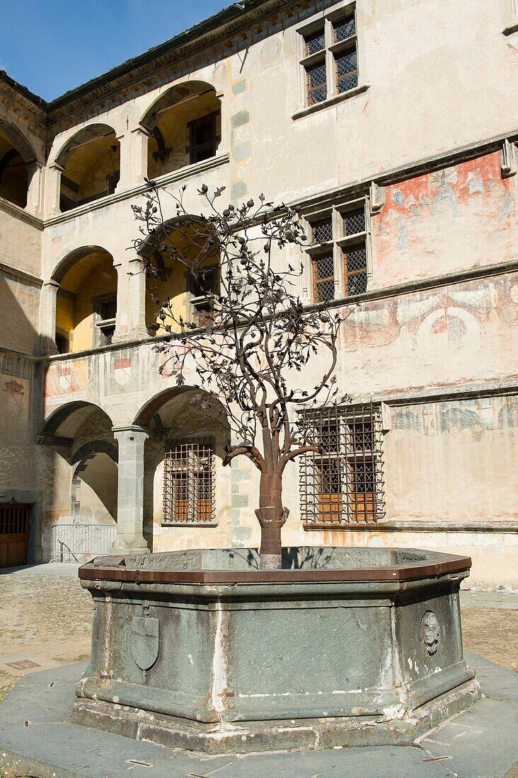 Italy, Aosta Valley, the castle of Issogne, the fountain of the metal pomegranate tree in the inner courtyard