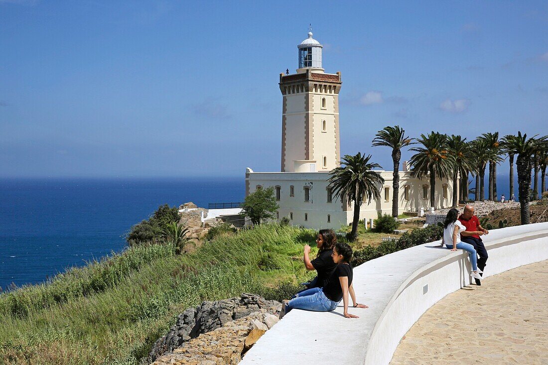 Morocco, Tangier Tetouan region, Tangier, Moroccan tourists sitting in front of the Cape Spartel lighthouse overlooking the Mediterranean