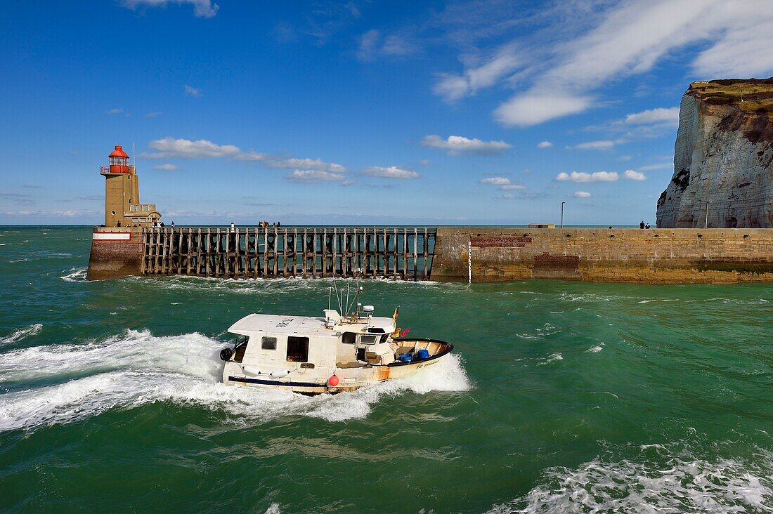 France, Seine Maritime, Pays de Caux, Cote d'Albatre, Fecamp, return to the port of a boat for whelk fishing in front of the Pointe Fagnet lighthouse