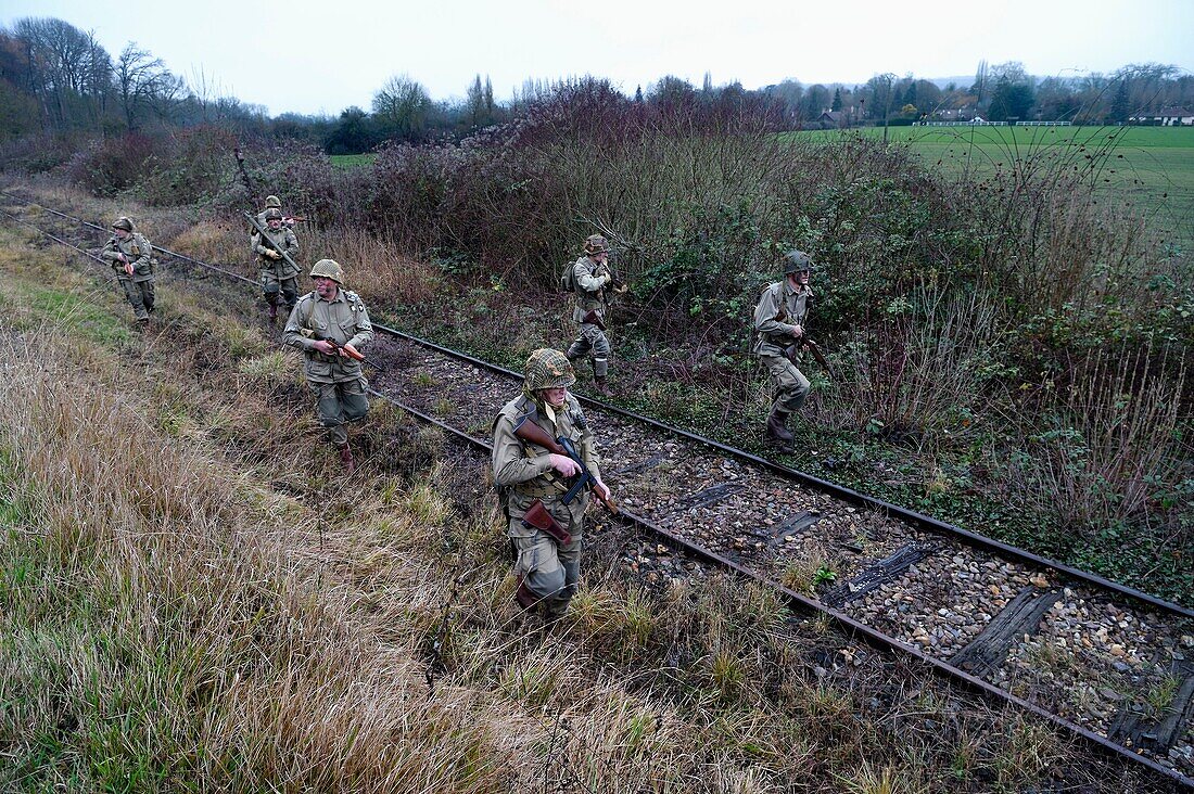 France, Eure, Cocherel, Allied Reconstitution Group (US World War 2 and french Maquis historical reconstruction Association), reenactors in uniform of the 101st US Airborne Division progressing along a railroad track