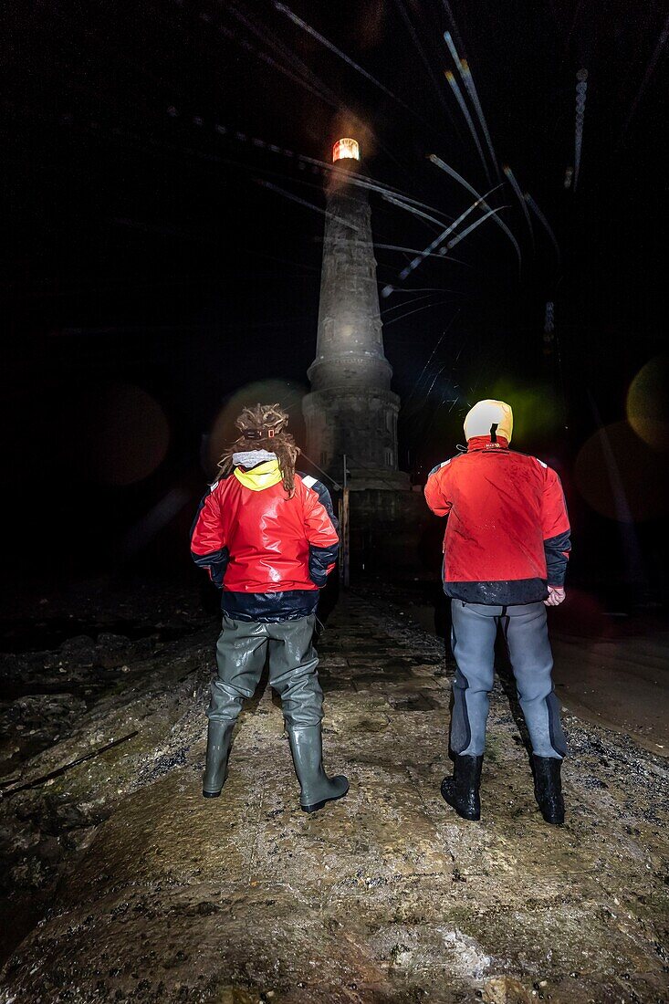 France, Gironde, Verdon sur Mer, rocky plateau of Cordouan, lighthouse of Cordouan, listed as Monument Historique, lighthouse keepers on the rocky plateau at night at low tide