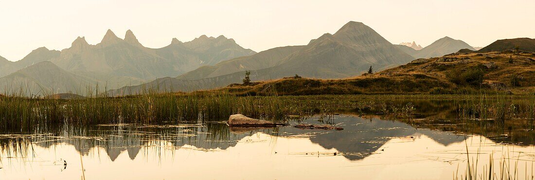 France, Savoie, Saint Jean de Maurienne, the largest bike trail in the world was created within a radius of 50 km around the city. At the cross of the Iron Cross, panoramic view of the hands of Arves reflecting in Lake Guichard at sunrise