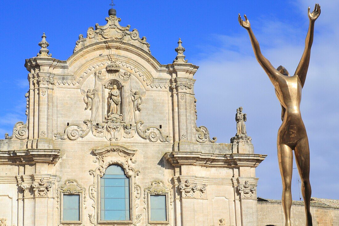 Italy, Basilicata, Matera, European Capital of Culture 2019, Piazza San Francesco, Baroque facade (18th century) of the Church of St. Francis of Assisi (San Francesco d'Assisi) with a sculpture of Salvador Dalí in the foreground