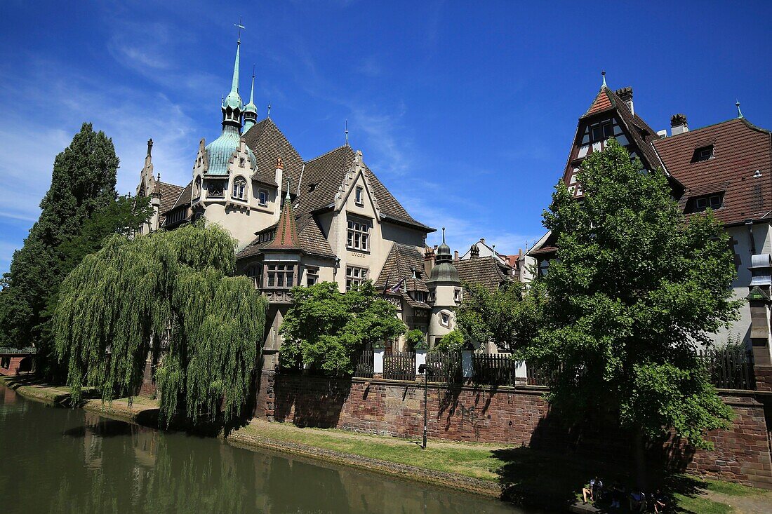 France, Bas Rhin, Strasbourg, district of Neustadt dating from the German period listed as a UNESCO World Heritage Site, the Faux Remparts canal and the Pontonniers high school at 1, rue des Pontonniers