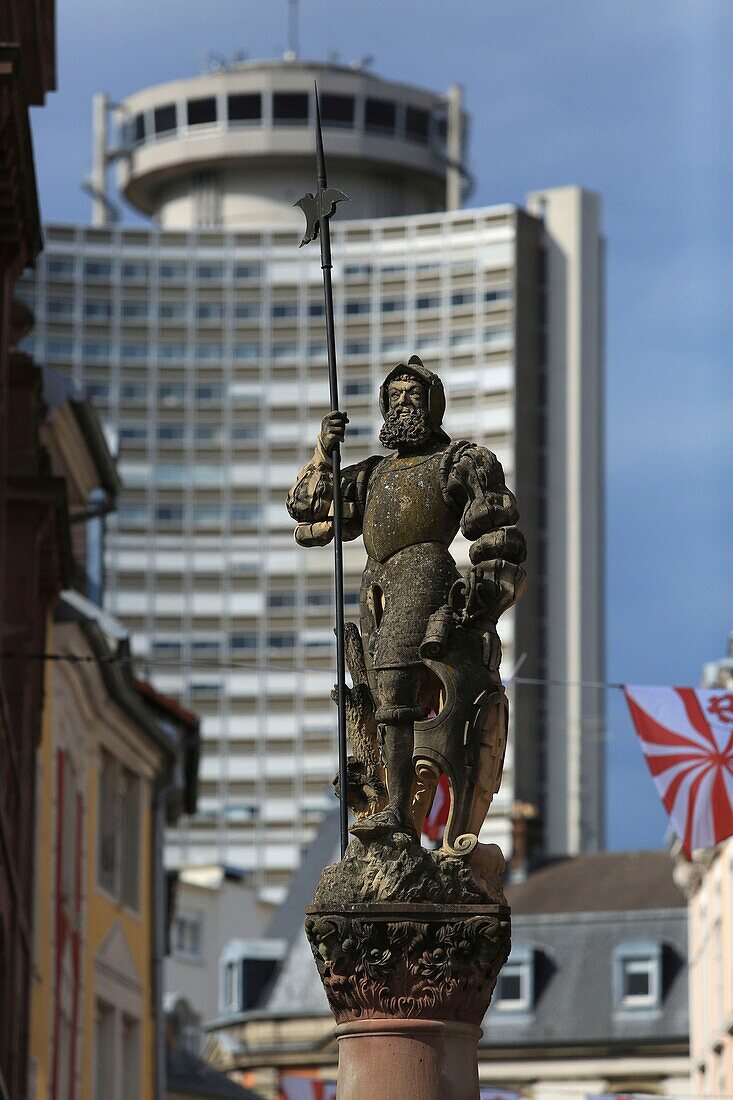 France, Haut Rhin, Mulhouse, at the intersection of Place de la Reunion and Rue Mercière, The Hallebardier fountain and the tower of Europe in the background