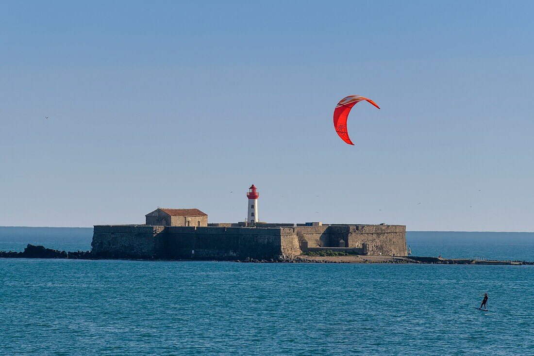 France, Herault, Agde, Cape of Agde, Kite surfer with Brescou Fort in background