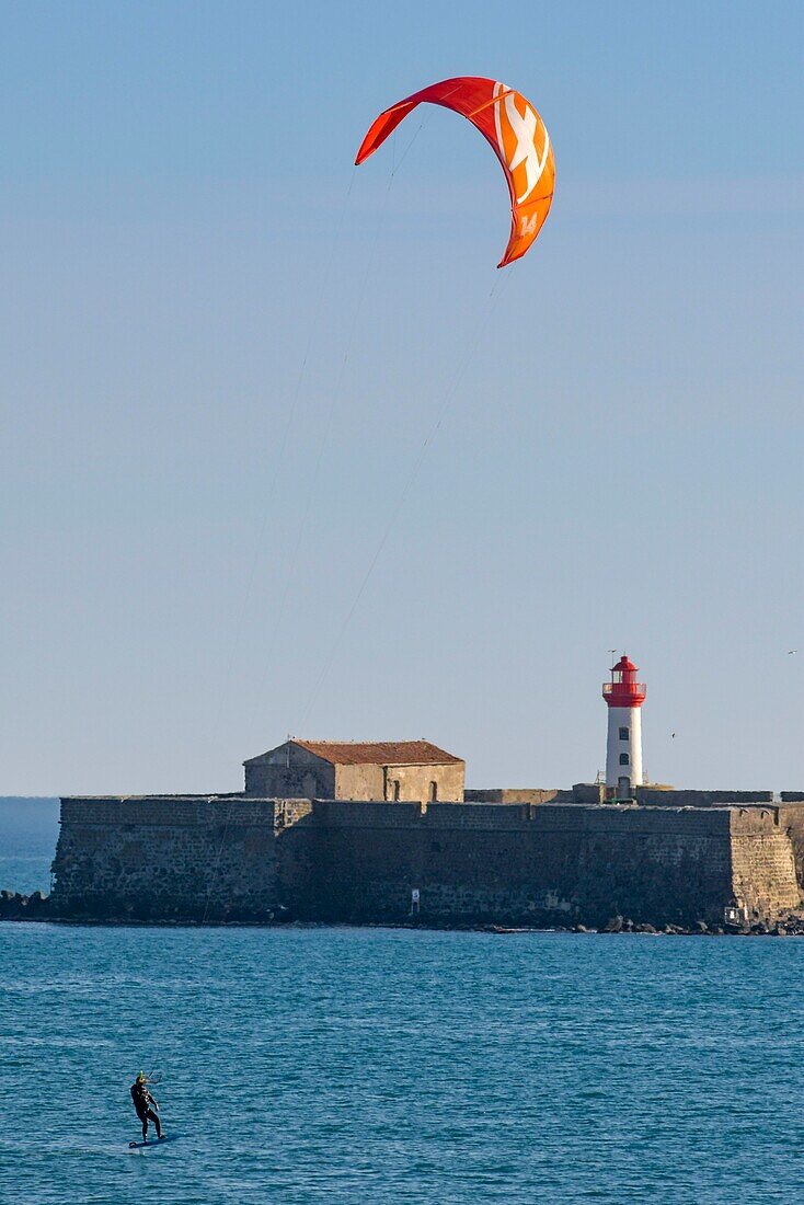 France, Herault, Agde, Cape of Agde, Kite surfer with Brescou Fort in background