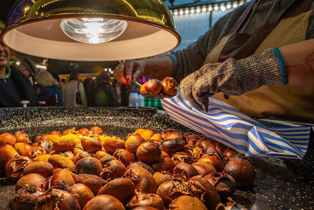 View of roast chestnut stall on Christmas Market, St. Georges Hall, Liverpool City Centre, Liverpool, Merseyside, England, United Kingdom, Europe
