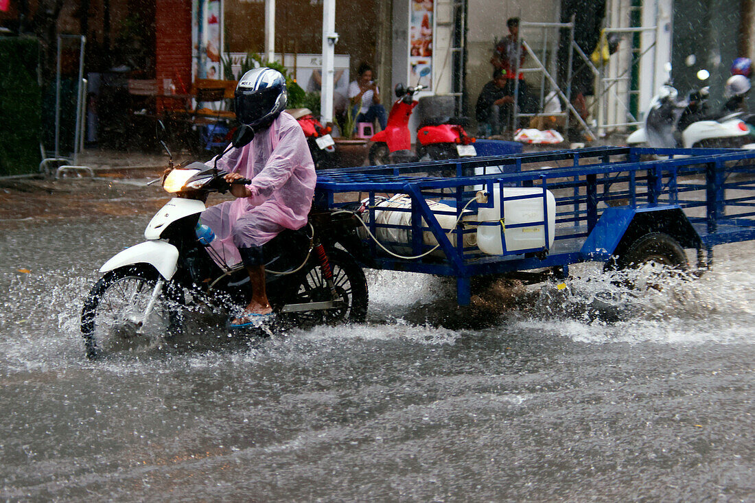 Heavy rain and water logging on road during Monsoon season, Phnom Penh, Cambodia, Indochina, Southeast Asia, Asia