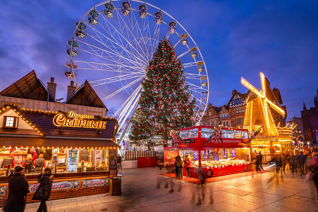 View of ferris wheel and Christmas Market on Old Market Square at dusk, Nottingham, Nottinghamshire, England, United Kingdom, Europe