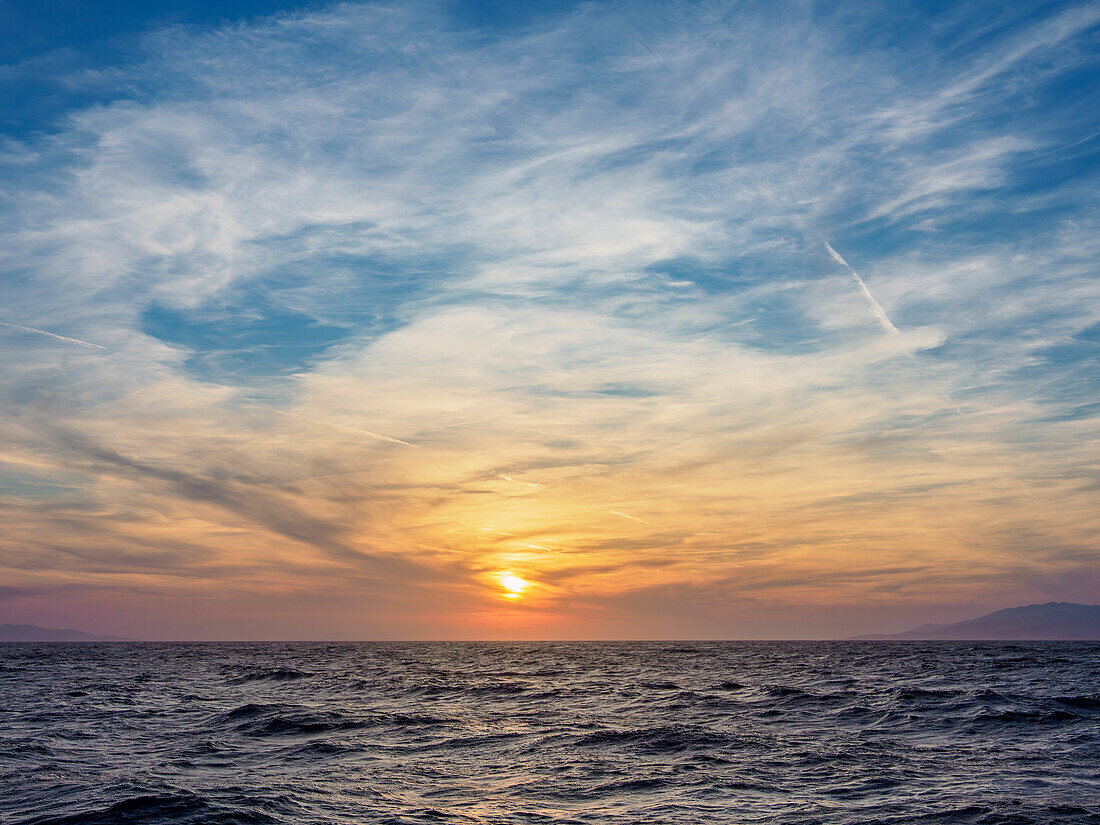 Sunset near the coast of Mykonos Island, Cyclades, Greek Islands, Greece, Europe