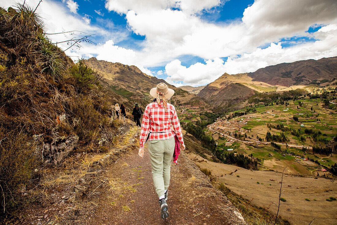 Woman walking along trails, Sacred Valley, Peru, South America