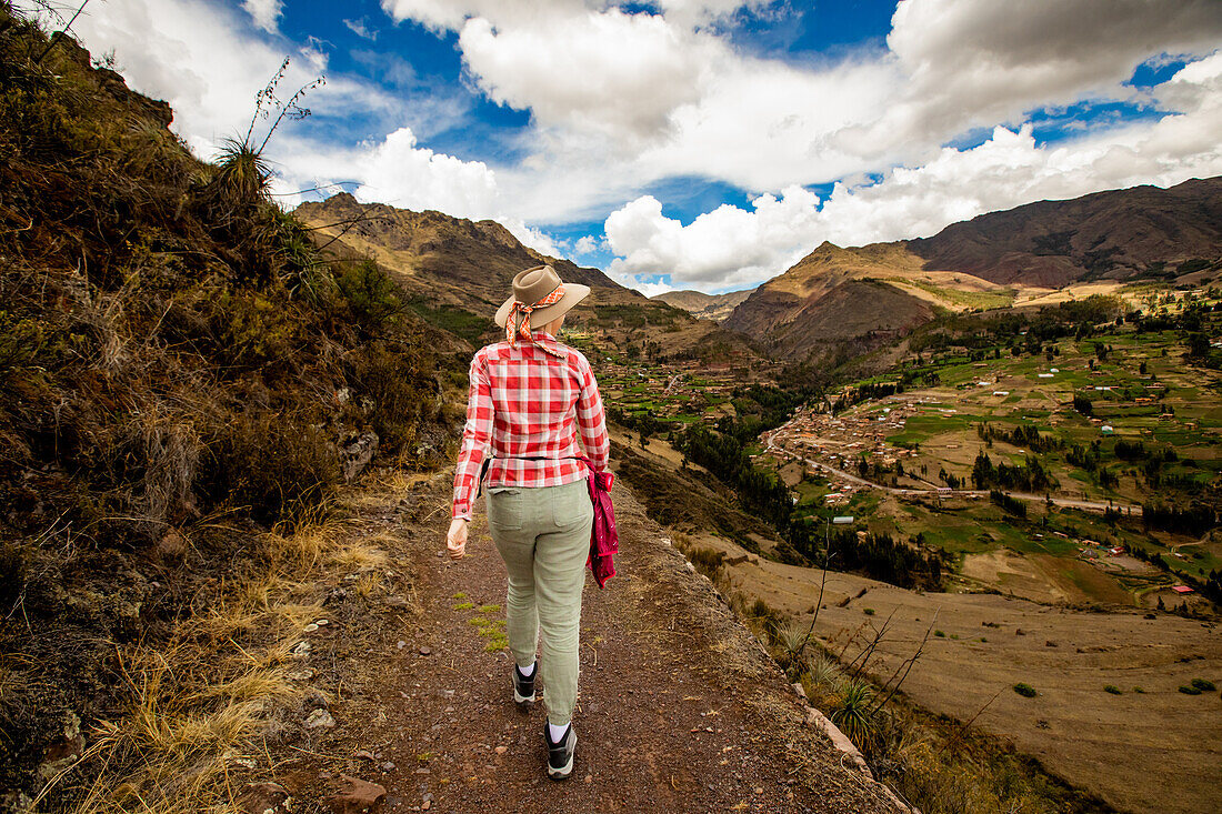 Woman walking along trails, Sacred Valley, Peru, South America