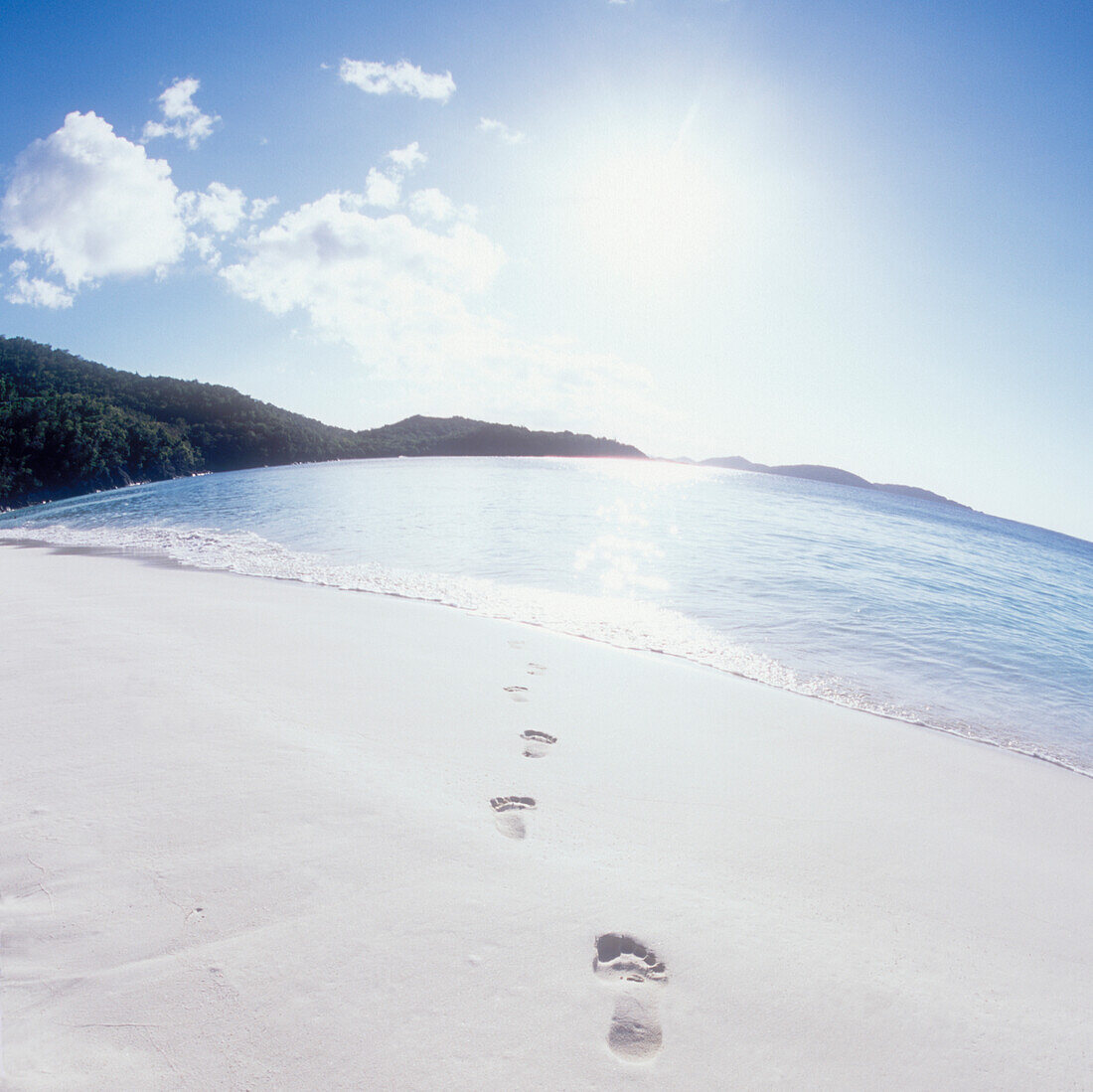 USA, United States Virgin Islands, St. John, Footprints on empty beach and calm sea