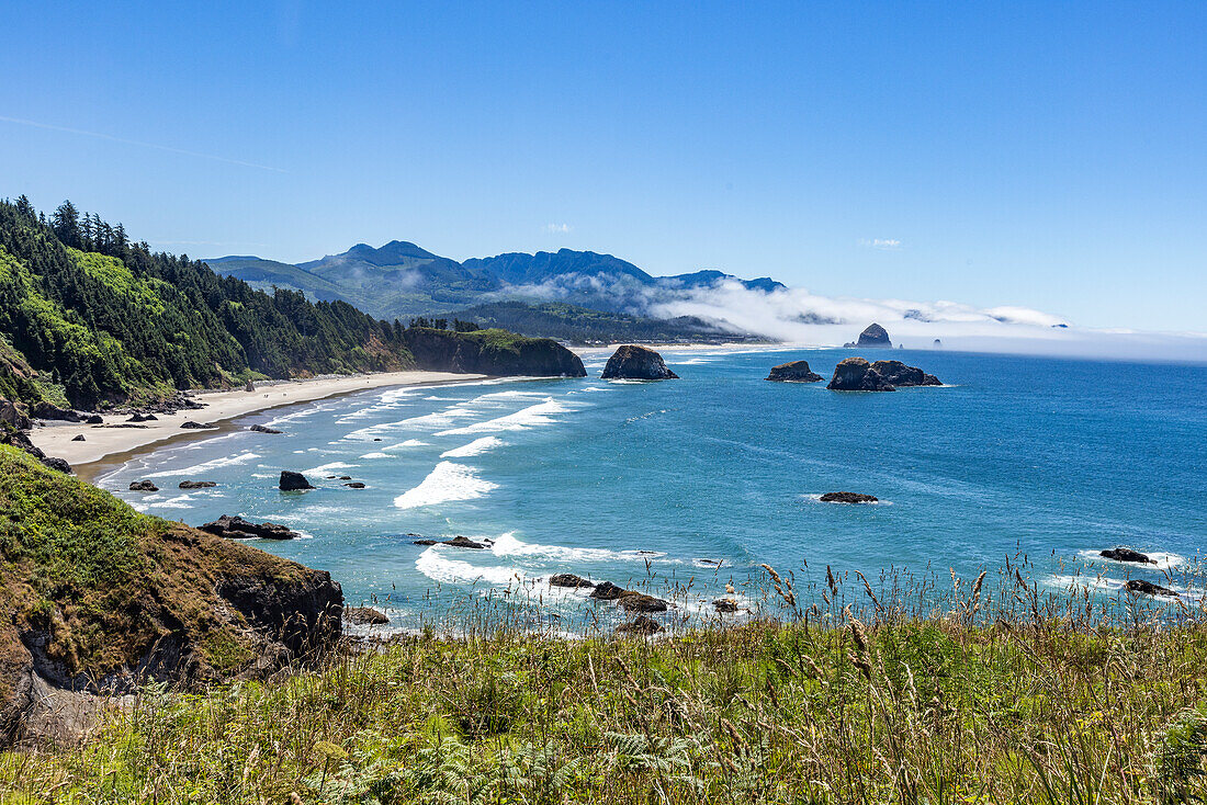 USA, Oregon, Coastline of Cannon Beach with rock formations 