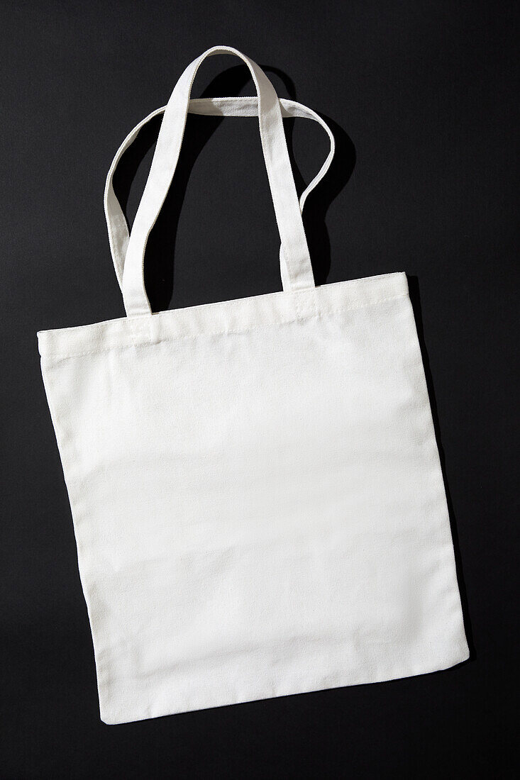 White tote bag against black background